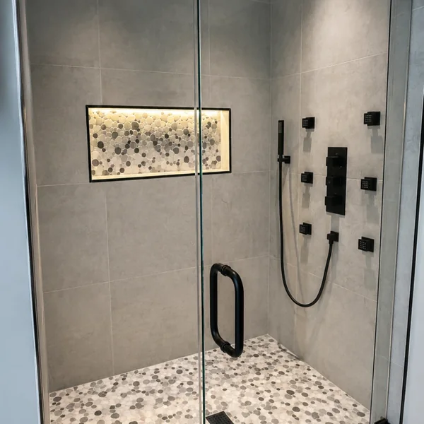 Walk-in shower with pebble mosaic floor and lit niche, Fairfield County CT